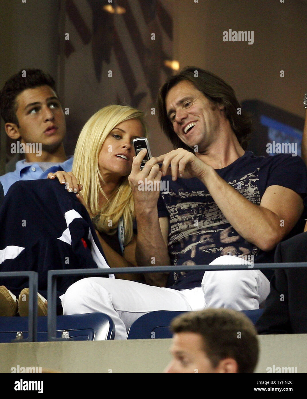 Jim Carrey And Jenny Mccarthy Play With A Cell Phone While Maria Sharapova Defeats Justine Henin Hardenne 6 4 6 4 At The U S Open In Flushing Meadows New York On September 9 2006 Upi