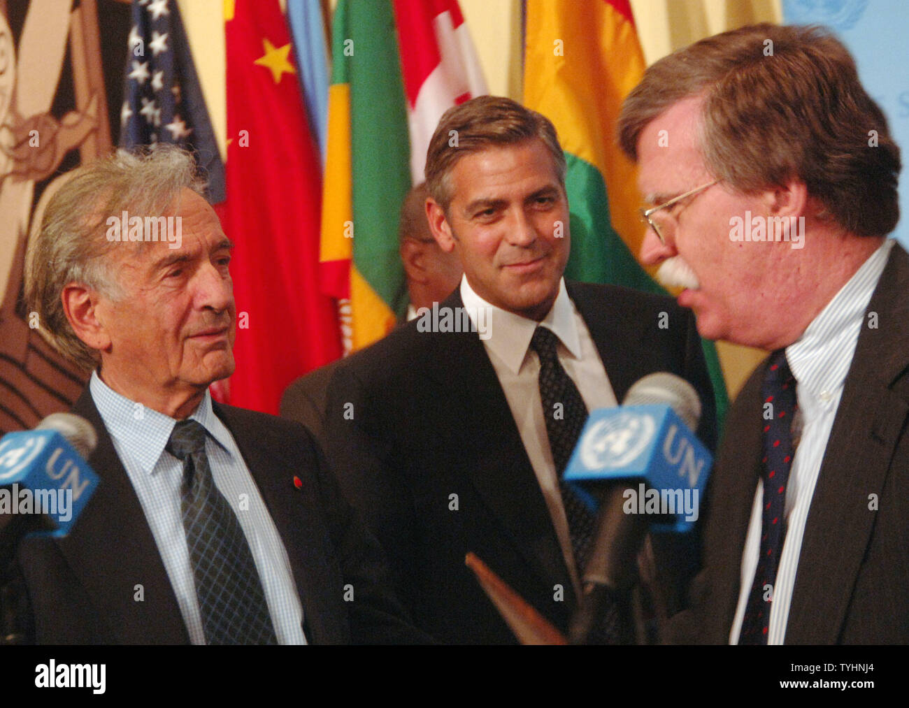 Nobel Peace Prize winner Dr. Elie Wiesel ,actor/producer George Clooney and US Ambassador to UN John Bolton (left to right) meet the UN media after a 'Arria' style meeting of the United Nations Security Council members on the subject of Dafur, Sudan on September 14, 2006 in New York. The meeting was called for by the U.S. Mission to the UN and the Elie Wiesel Foundation.   (UPI Photo/Ezio Petersen) Stock Photo
