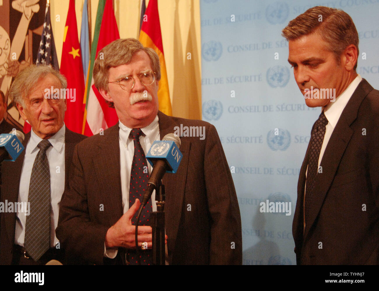 Nobel Peace Prize winner Dr. Elie Wiesel ,a US Ambassador to UN John Bolton and actor/producer George Clooney (left to right) meet the UN media after a 'Arria' style meeting of the United Nations Security Council members on the subject of Dafur, Sudan on September 14, 2006 in New York. The meeting was called for by the U.S. Mission to the UN and the Elie Wiesel Foundation.   (UPI Photo/Ezio Petersen) Stock Photo