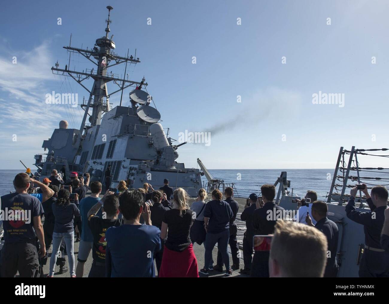 OCEAN (Nov. 9, 2016) Sailors assigned to the guided-missile destroyer USS Spruance (DDG 111) and embarked friends and family members aboard during a tiger cruise watch a demonstration of the ship’s close-in weapons system in the Pacific Ocean, Nov. 9, 2016. Spruance and the guided-missile destroyers USS Decatur (DDG 73) and USS Momsen (DDG 92), along with embarked “Warbirds” and “Devilfish” detachments of Helicopter Maritime Strike Squadron (HSM) 49, are finishing up a seven-month deployment in support of maritime security and stability in the Indo-Asia-Pacific as part of a U.S. 3rd Fleet Paci Stock Photo