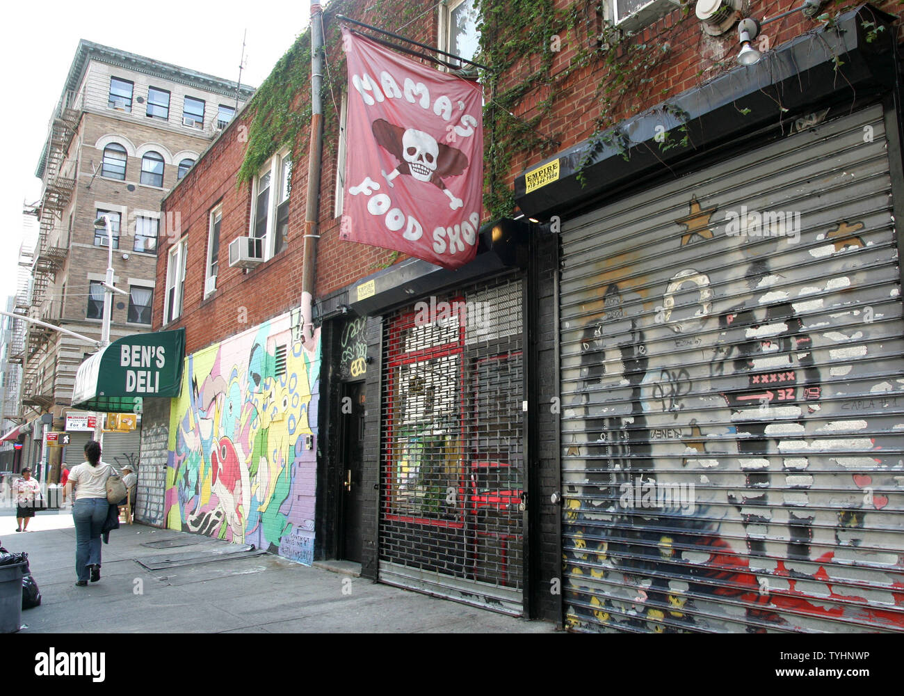 People walk along the sidewalks in the Lower East Side, also known