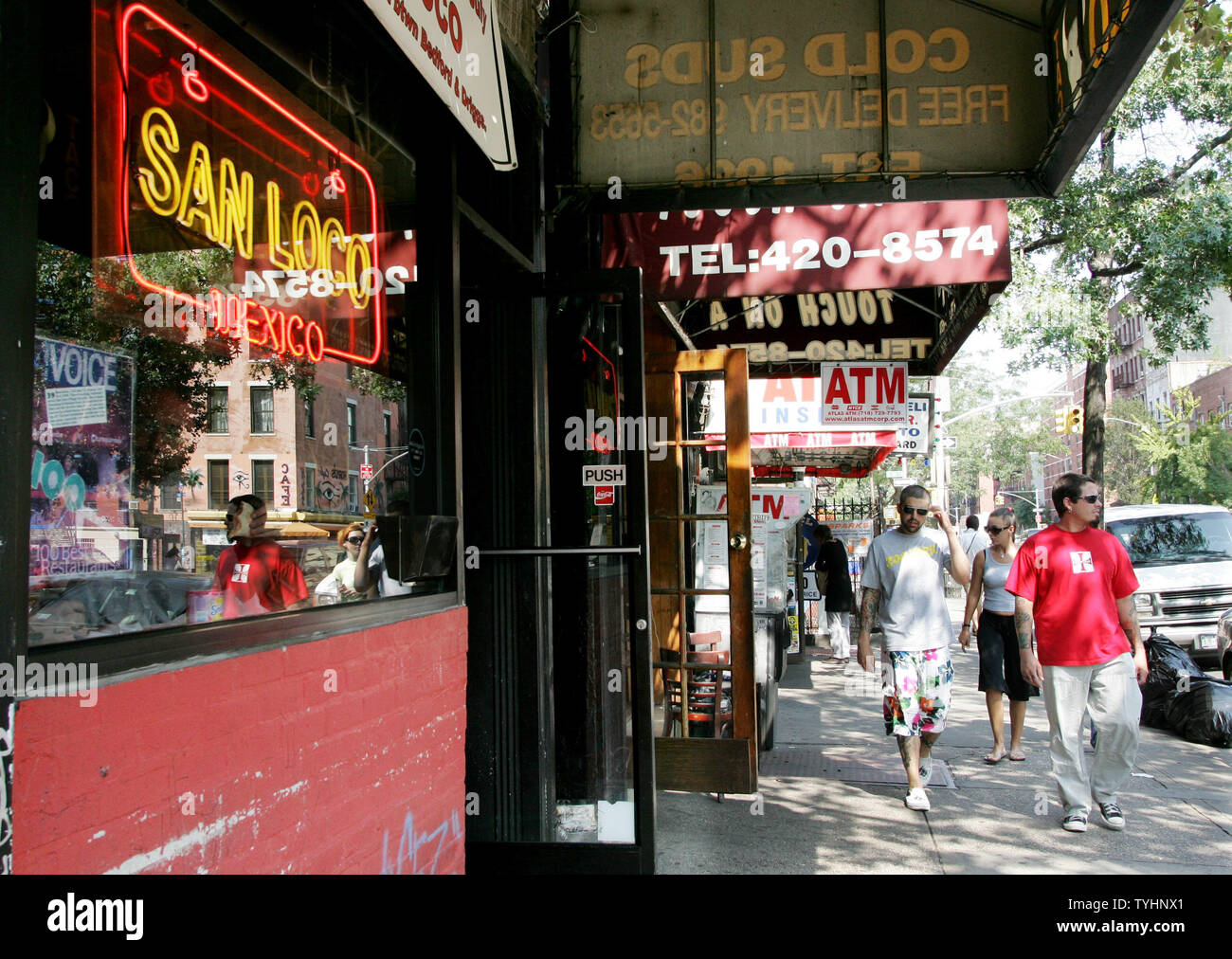 People walk along the sidewalks in the Lower East Side, also known