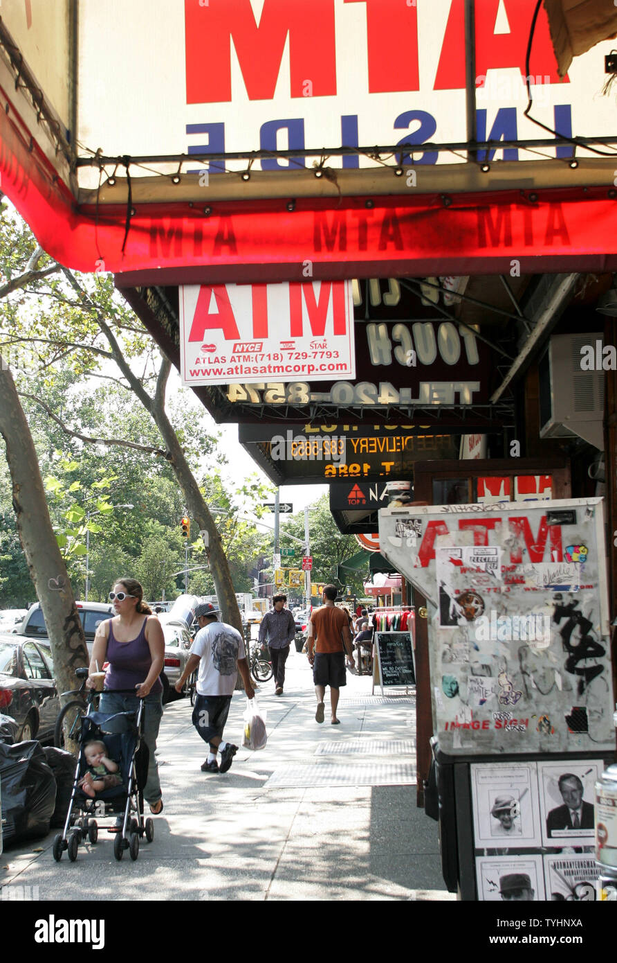 People walk along the sidewalks in the Lower East Side, also known