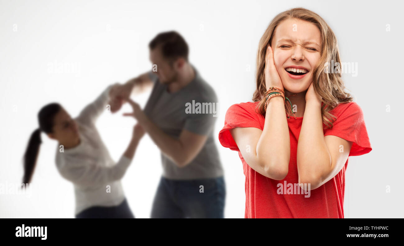 girl covering ears over her parents having fight Stock Photo