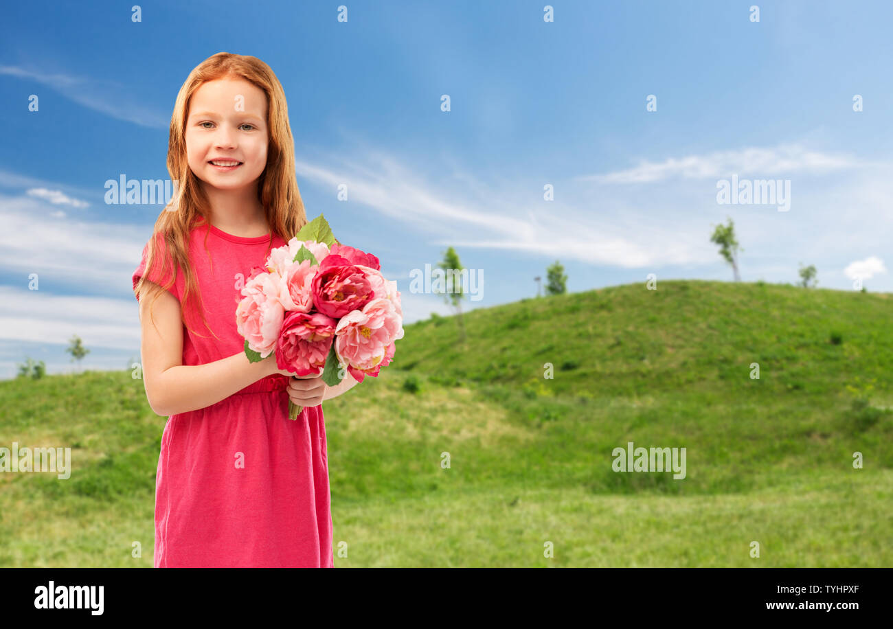 happy red haired girl with flowers Stock Photo