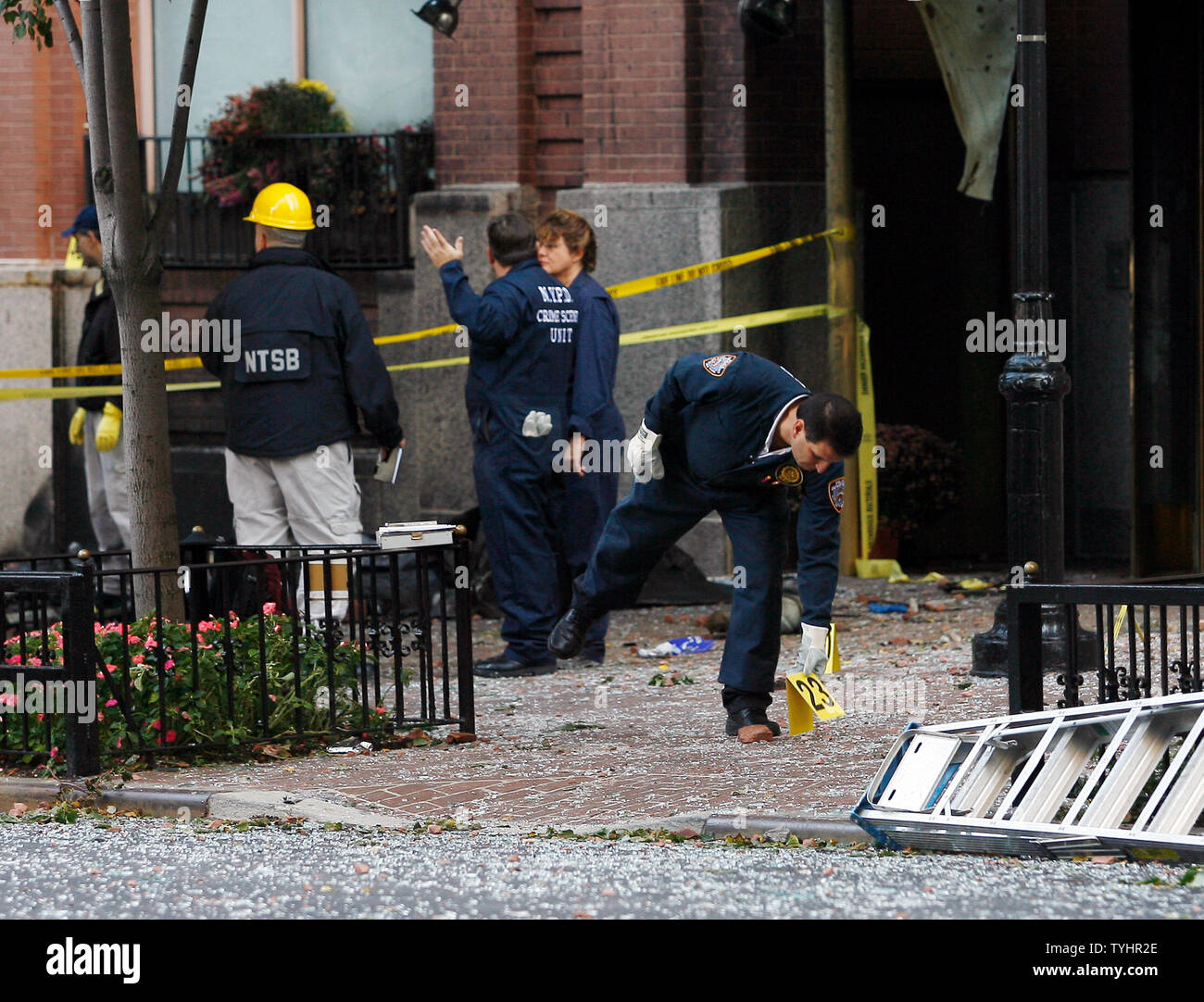 An investigators moves a numbered sign labeling wreckage from the plane