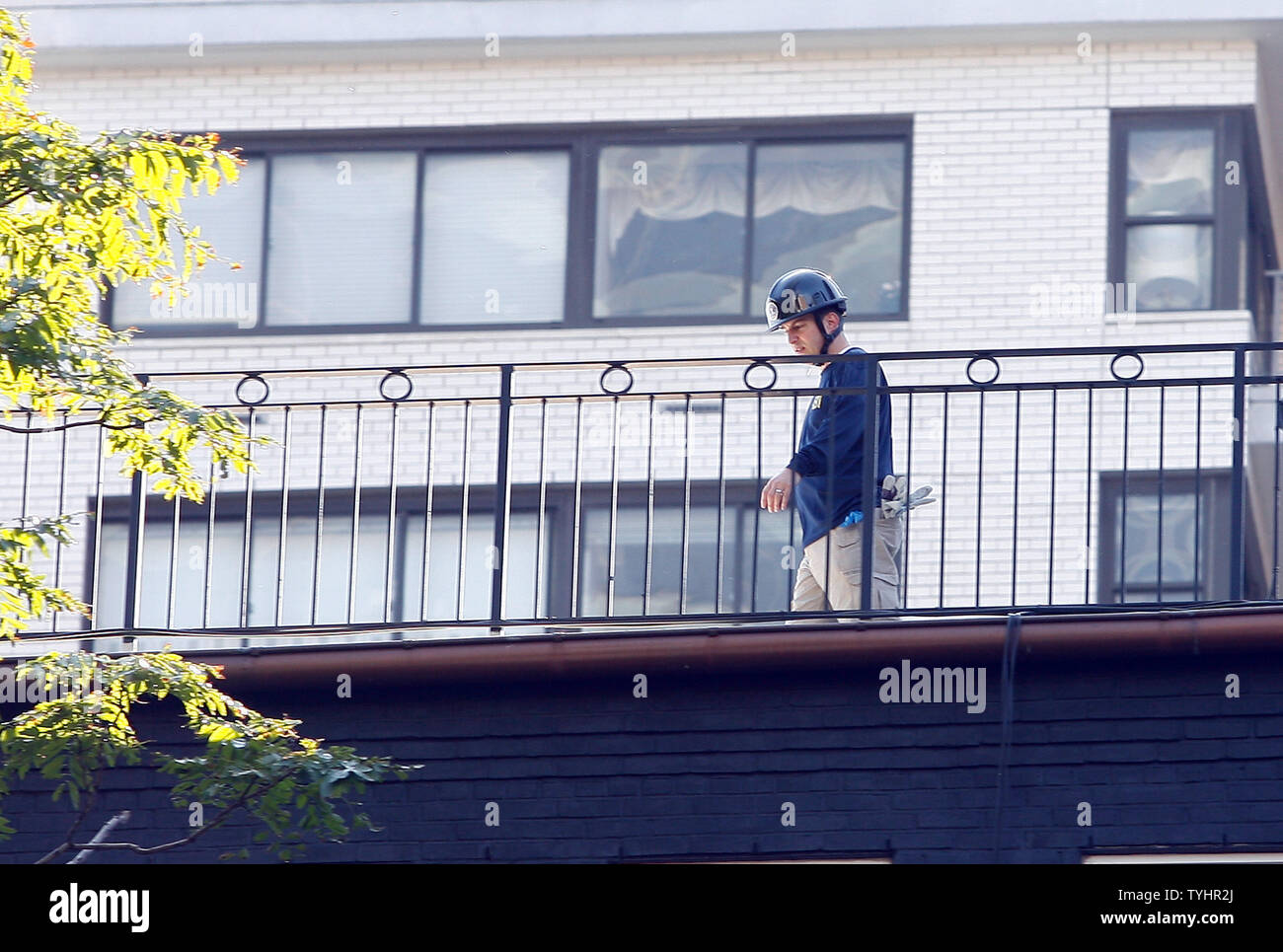 Police look for evidence on roof tops around the plane crash site of