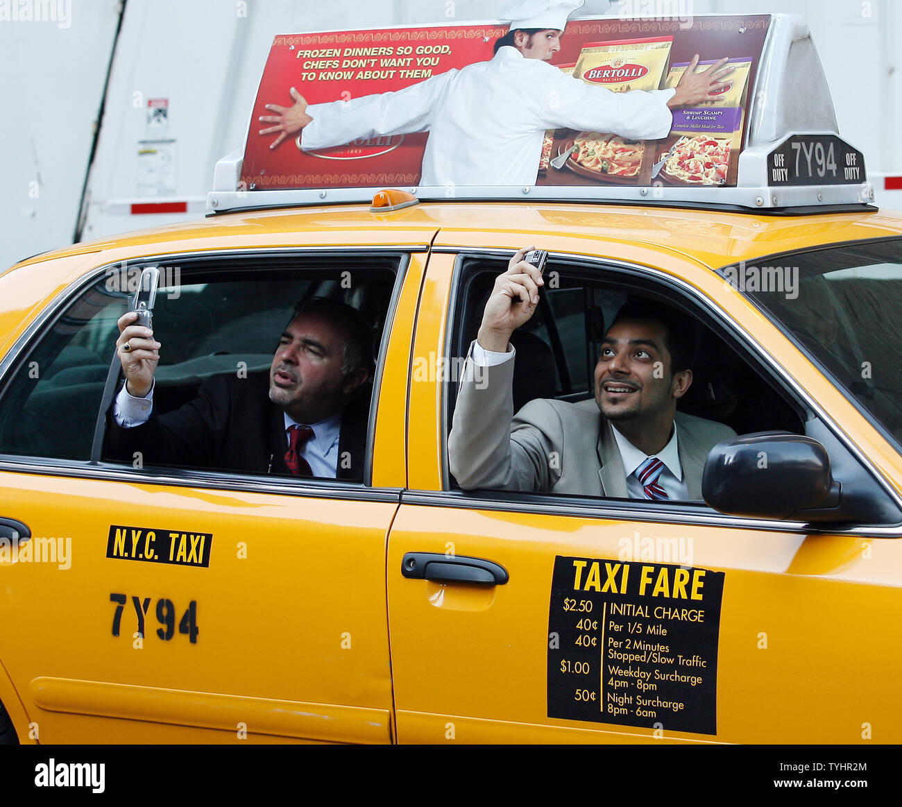 People use their cell phones to take pictures around the plane crash