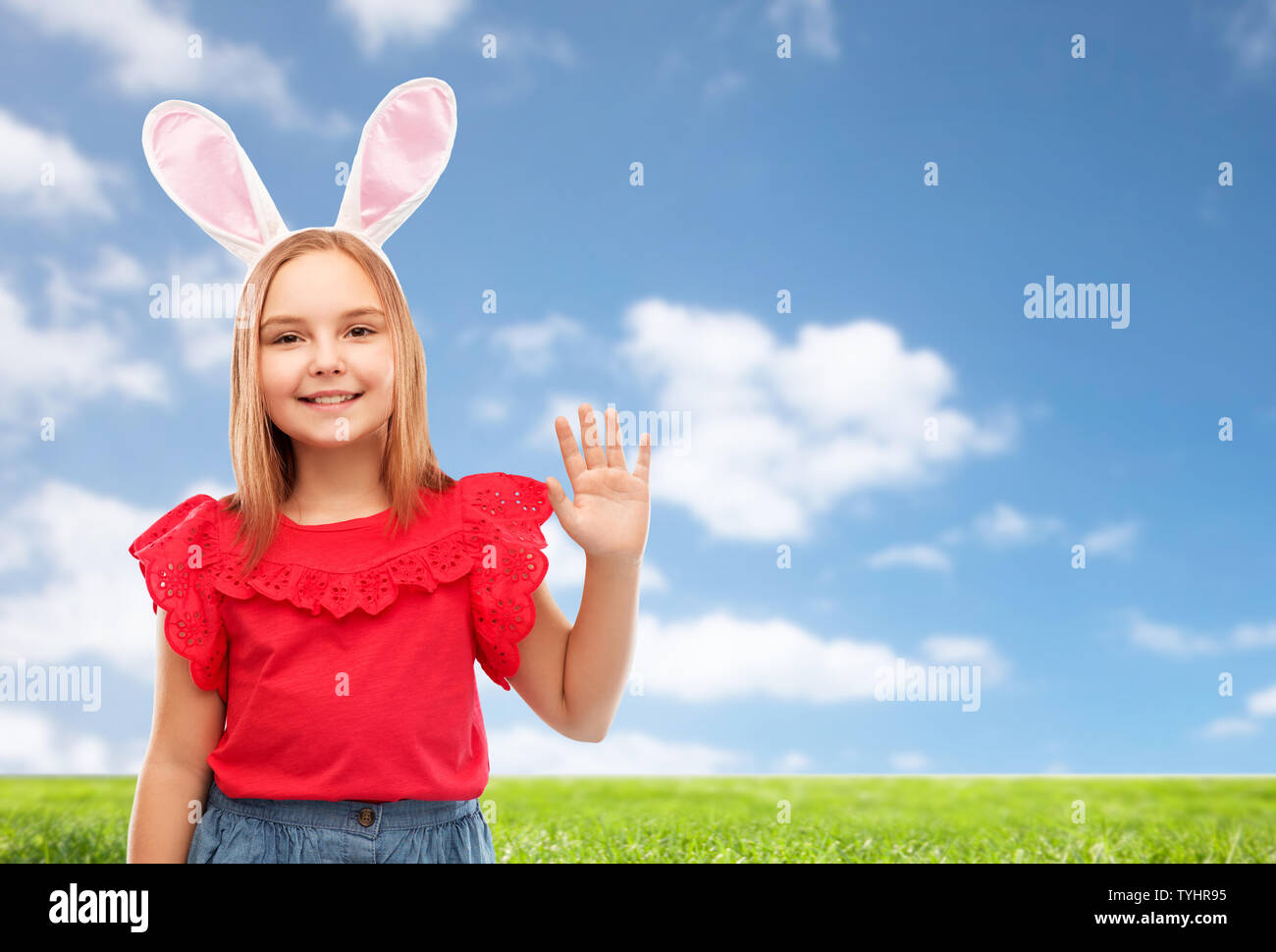 happy girl wearing easter bunny ears waving hand Stock Photo Alamy