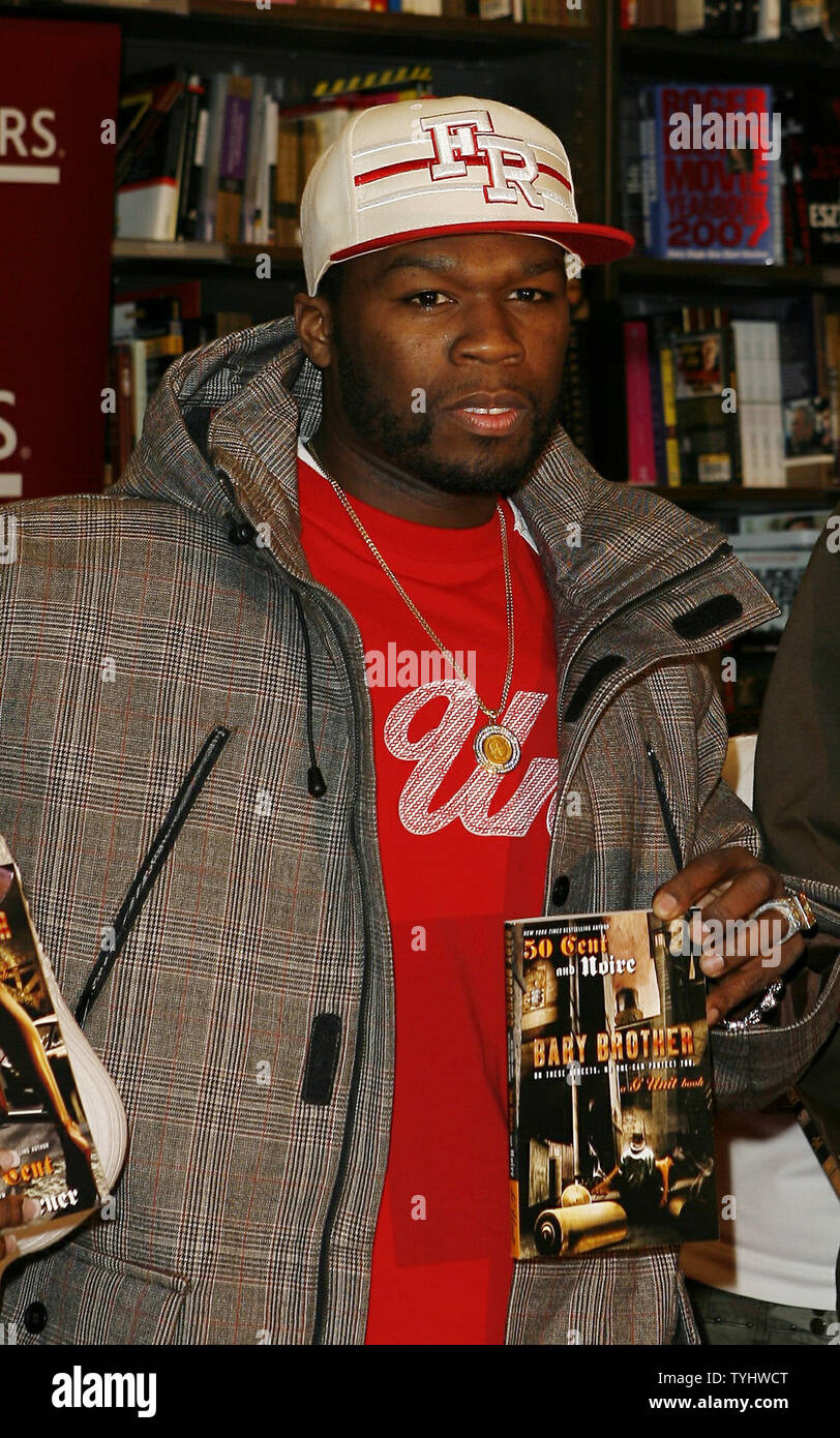 50 Cent holds copies of "Death Before Dishonor", "Baby Brother" and "The  Ski Mask Way To Celebrate The Launch Of G-Unit Books" during a book signing  at Borders in New York City
