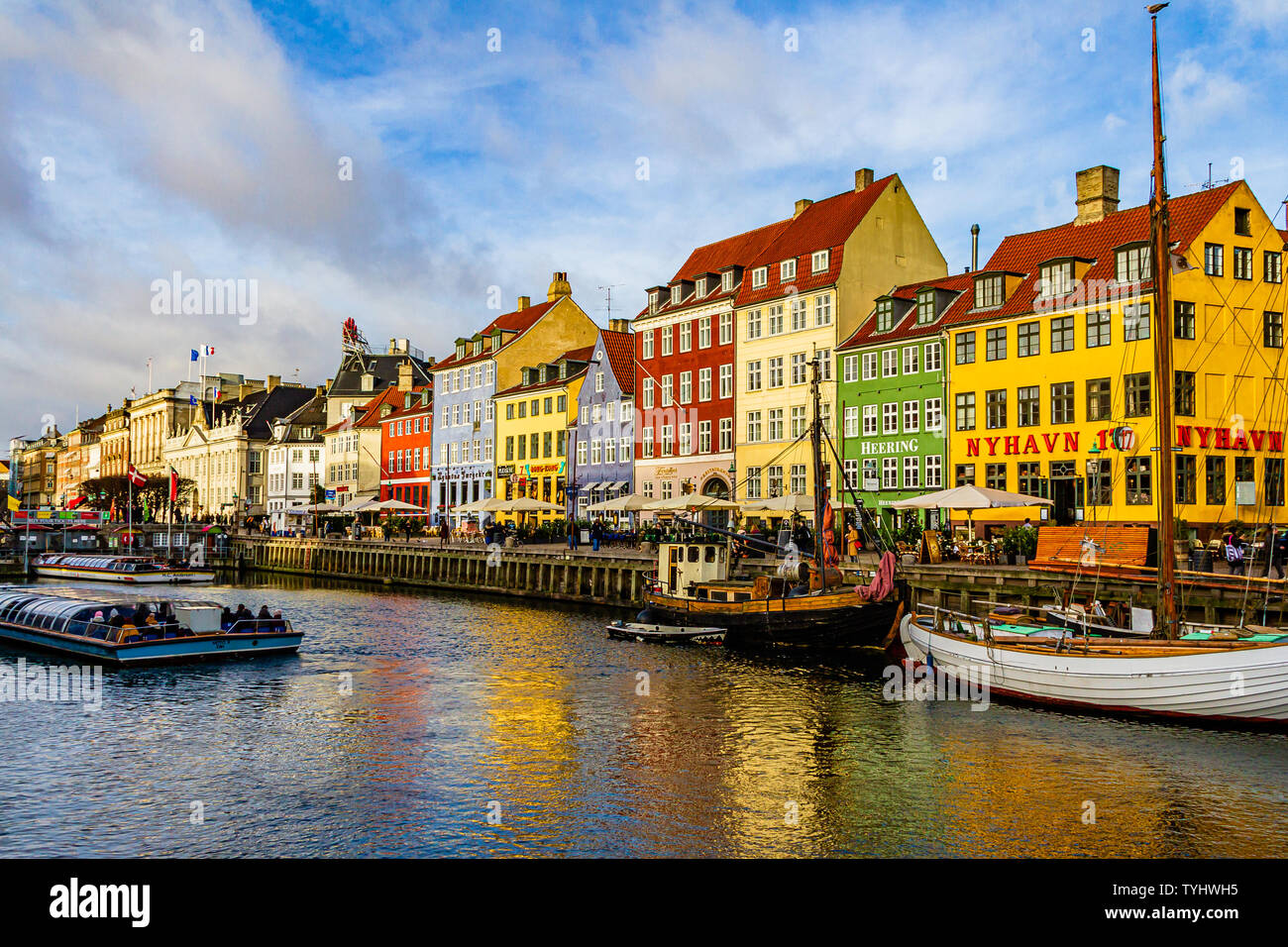 Nyhavn, a 17th century canal and harbour area with bars and restaurants and popular with tourists, in the capital city of Copenhagen, Denmark. 2019. Stock Photo
