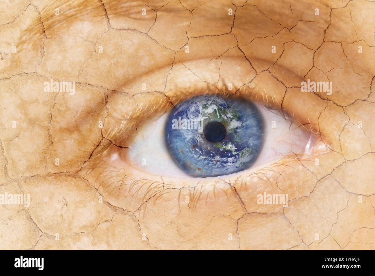 Global warming concept. Close up image of woman cracked textured face with iris earth. Creative composite of macro Eye with Earth as Iris. Elements of this image furnished by NASA . Stock Photo