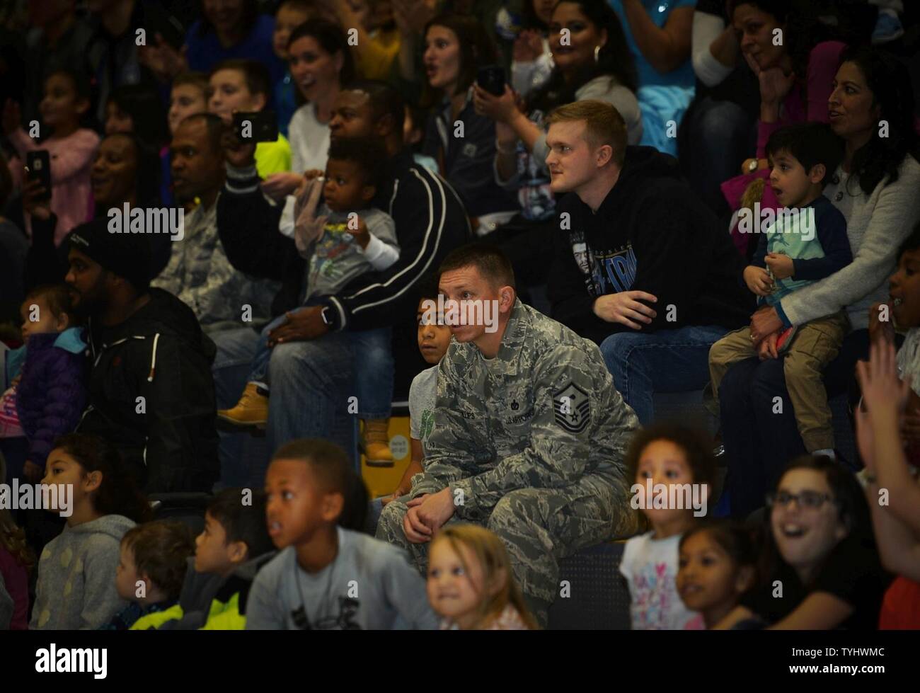 Airmen and their families watch a performance by the Harlem Globetrotters at Ramstein Air Base, Germany, Nov. 10, 2016. The basketball exhibition group has conducted tours for U.S. troops stationed overseas for more than ten years. Stock Photo