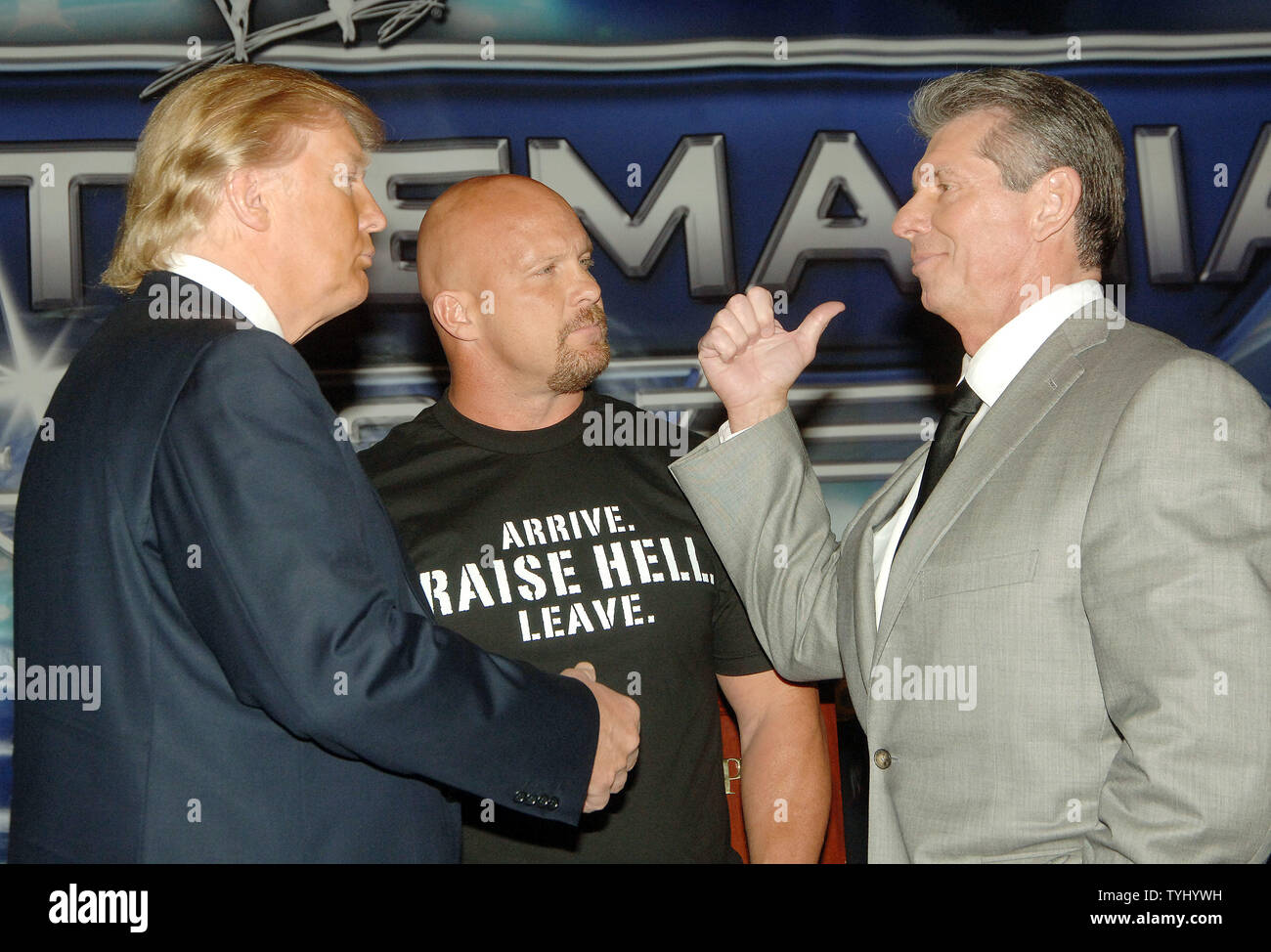 Wrestler/referee Stone Cold Steve Austin (C) looks on while World Wrestling Entertainment CEO Vince McMahon (R) pulls on the tie of business icon Donald Trump during a March 28, 2007 photo op in New York to announce their up coming 'Battle of the Billionaires' match on April 1, 2007 in Detroit. (UPI Photo/Ezio Petersen) Stock Photo