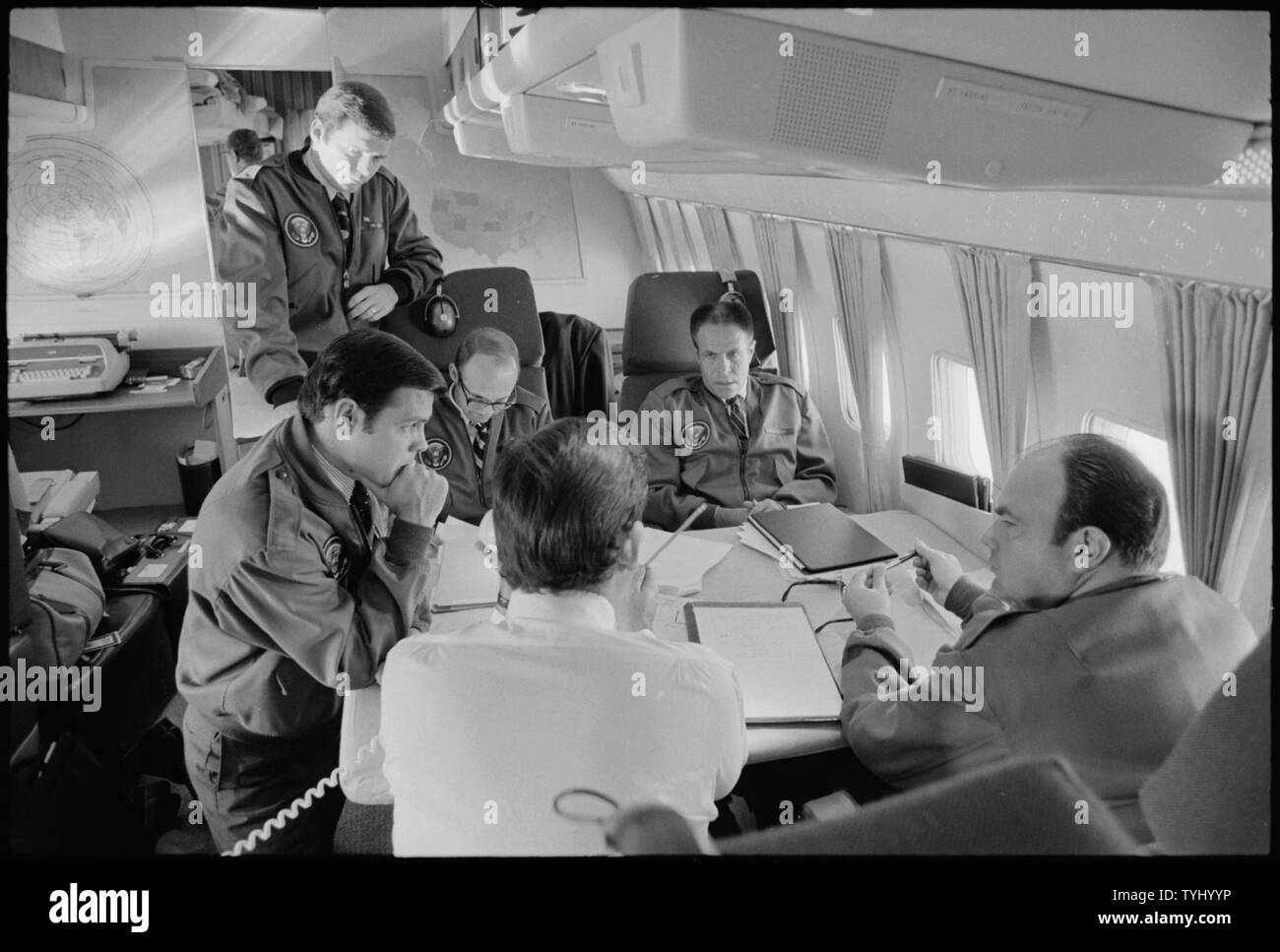 Richard M. Nixon staff members aboard Air Force One during the 1972 presidential campaign. Scope and content Pictured John Ehrlichman Ronald Ziegler Dwight Chapin. Subject Air Force One Stock Photo Al...