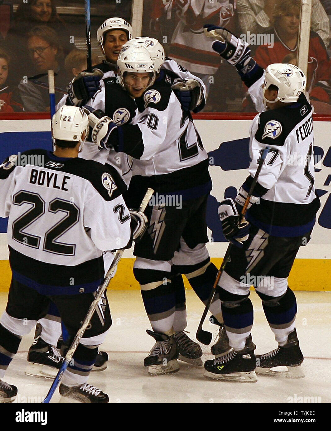 Tampa Bay Lightning Dan Boyle (22), Vaclav Prospal (20), and Ruslan Fedotenko (17) join in the celebration after Vincent Lecavalier scored a goal in the third period at the Continental Airlines Arena in East Rutherford, New Jersey on April 14, 2007.  The Tampa Bay Lightning defeated the New Jersey Devils 3-2.    (UPI Photo/John Angelillo) Stock Photo