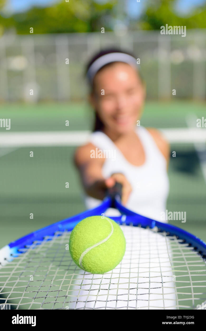 Tennis. Woman tennis player showing ball and racket on tennis court outside. Female tennis player. Stock Photo