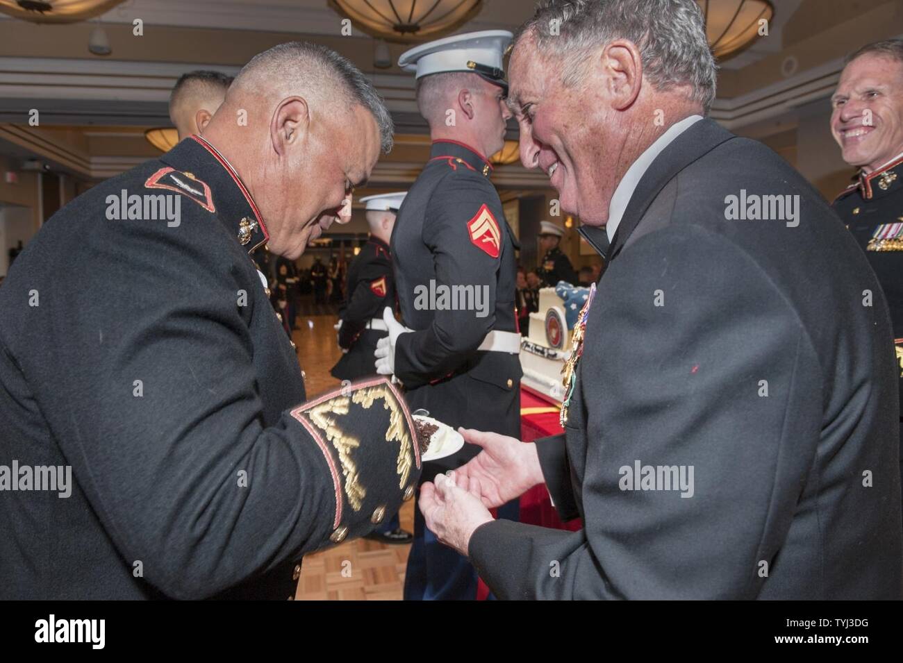 The oldest active duty marine present, left recieves the first peice of cake from U.S. Marine Corps Gen. Charles C. Krulak, ret. 31st Commandant of the Marine Corps, right, during the Marine Corps Combat Development Command and Combat Development and Integration 241st Marine Corps Birthday Ball, The Clubs at Quantico, Quantico, Va, Nov. 10, 2016. The attendees celebrated the 241st birthday with the reading of General John A. Lejeune’s birthday message and a traditional cake cutting ceremony. Stock Photo