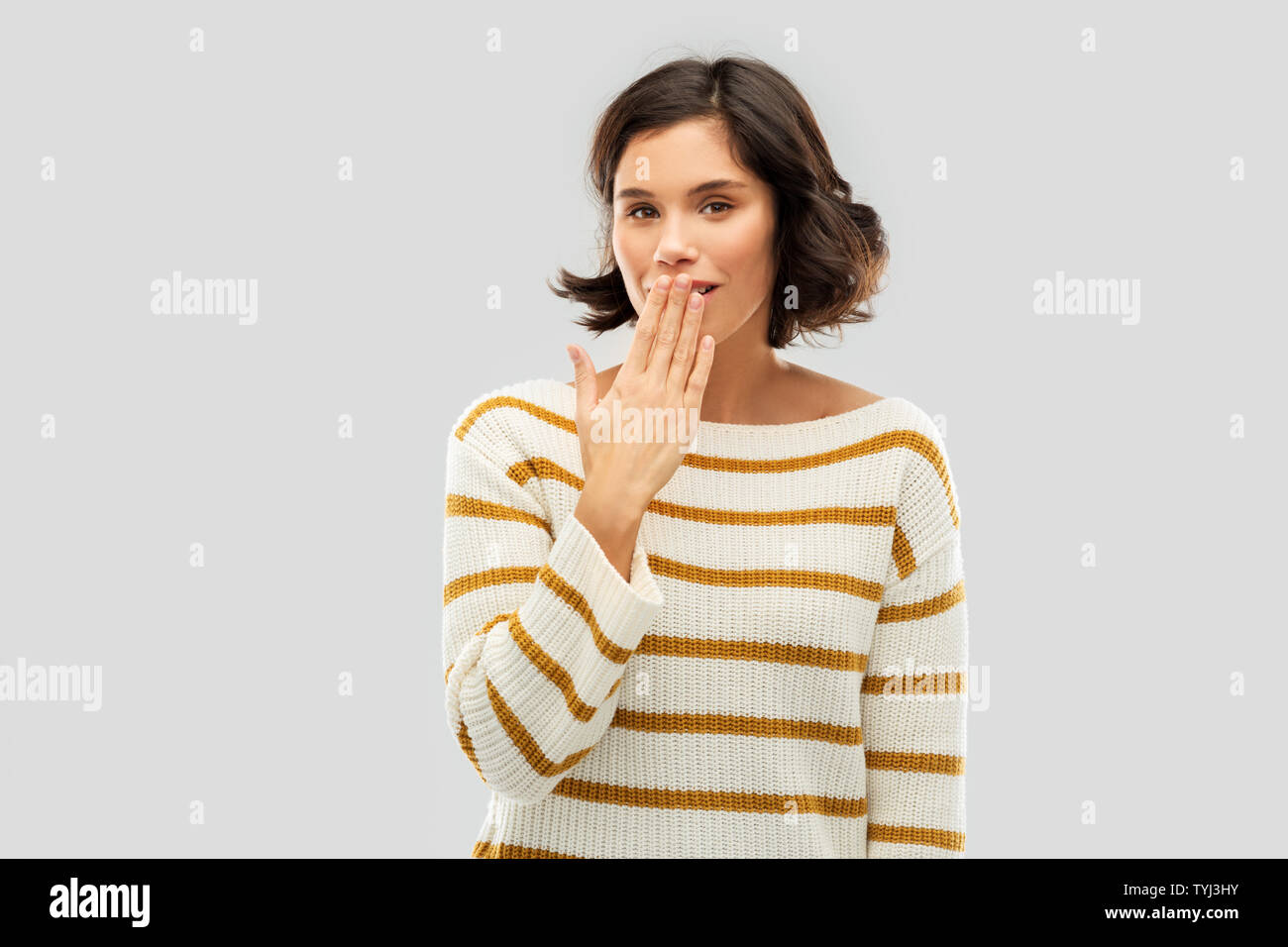 happy woman covering mouth by hand and giggling Stock Photo