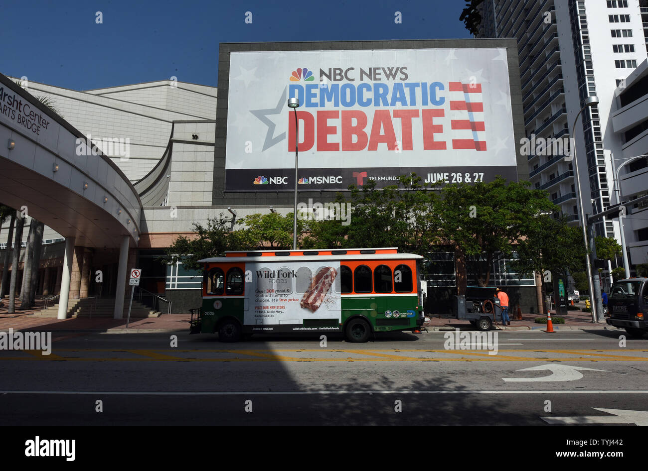 Miami, Florida, USA. 26th Jun 2019. A trolley drives past a billboard outside the Adrienne Arsht Center for the Performing Arts advertising the first Democratic presidential primary debates for the 2020 elections which will be held on June 26 and 27 in Miami, Florida. (Paul Hennessy/Alamy) Credit: Paul Hennessy/Alamy Live News Stock Photo