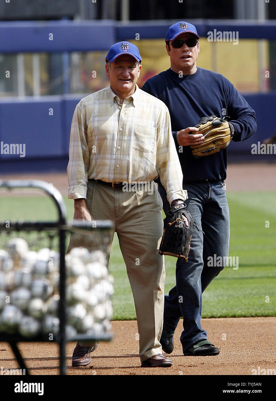 Robin Williams (L) and John Travolta play the infield while shooting the movie 'Old Dogs' at Shea Stadium in New York City on July 26, 2007.  (UPI Photo/John Angelillo) Stock Photo