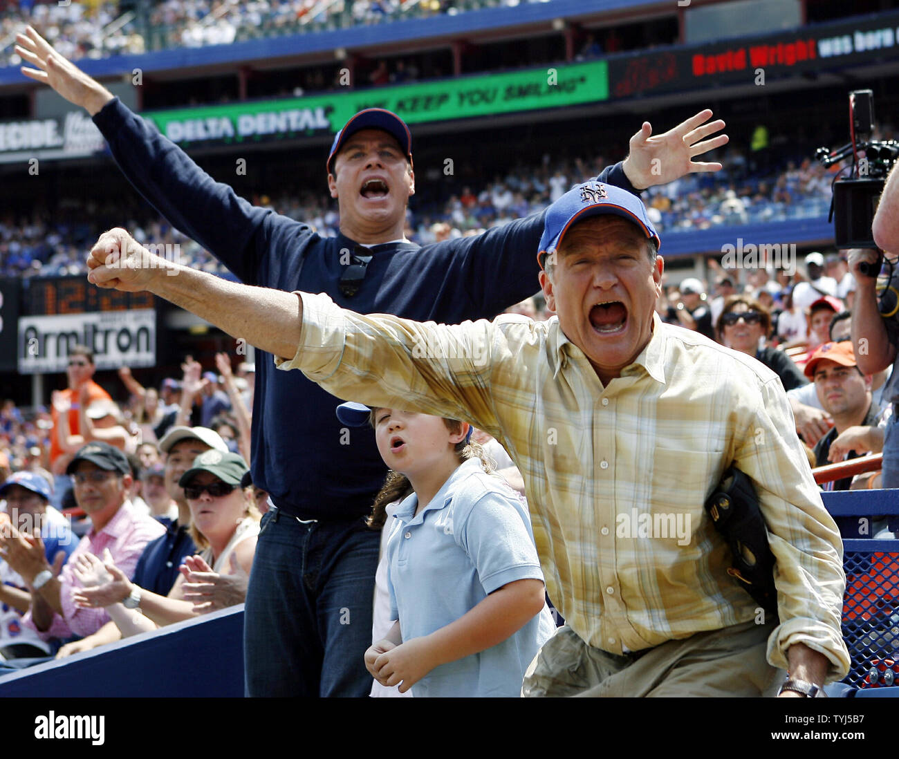 (L-R) John Travolta, Connor Rayburn and Robin Williams react while shooting the movie 'Old Dogs' at Shea Stadium in New York City on July 26, 2007.  (UPI Photo/John Angelillo) Stock Photo