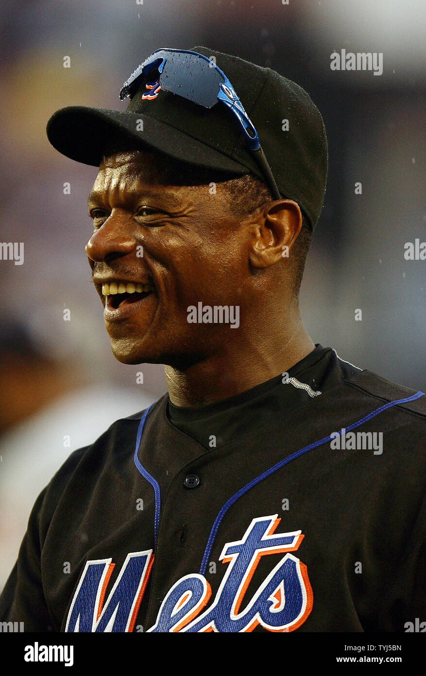 New York Mets first base coach Ricky Henderson smiles after a Ruben