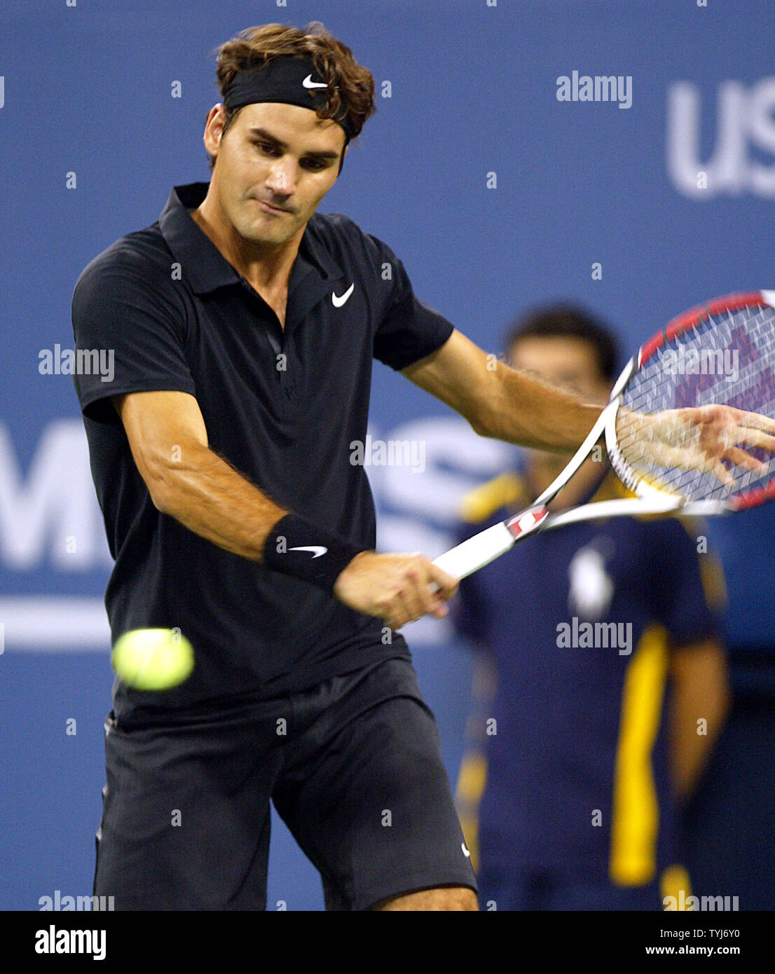 Roger Federer of Switzerland returns the ball to Feliciano Lopez of Spain  during Round Four of the U.S. Open at the USTA Billie Jean King National  Tennis Center in Flushing Meadows-Corona Park