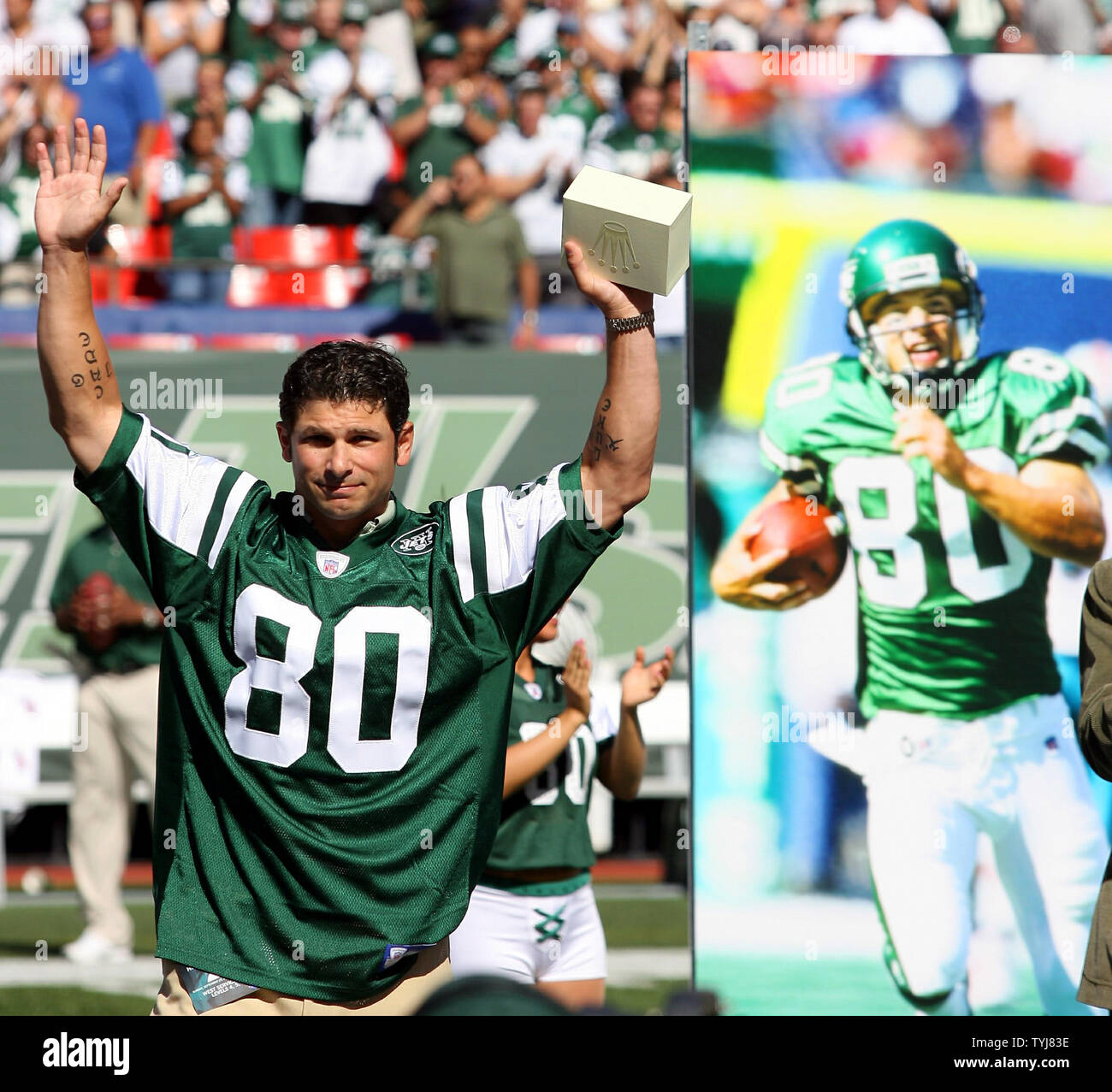 New York Jets wide receiver Wayne Chrebet puts his hands in the air while  being honored during half time of the Miami Dolphins, New York Jets game at  Giants Stadium in East