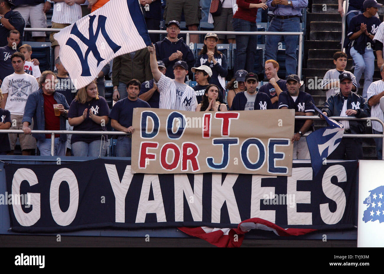 New York Yankees fans hold up signs supporting Yankees manager Joe Torre in  the first inning against the Cleveland Indians during game 3 of the ALDS  against the New York Yankees at