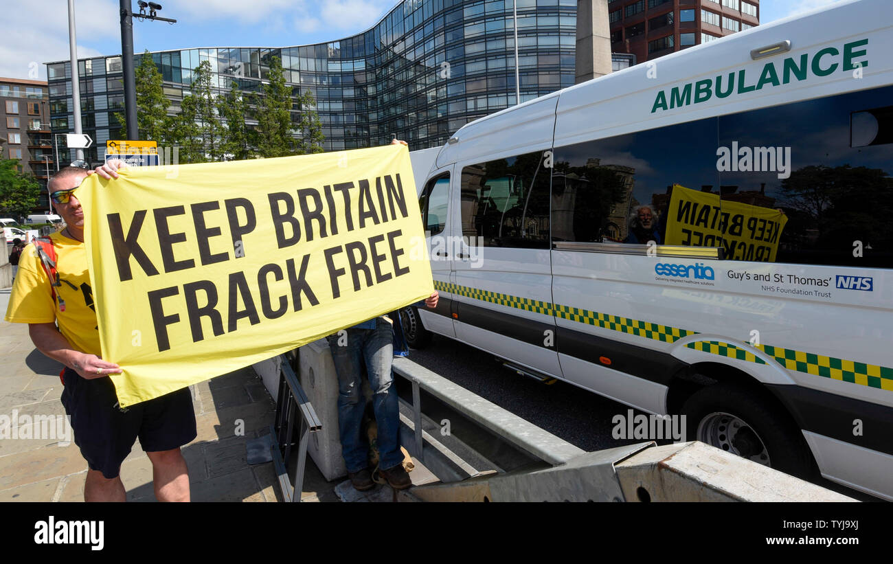 London, UK.  26 June 2019.  Men hold up an anti-fracking sign during a 'Time Is Now' mass lobby around Parliament.  Activists are attempting to deliver a message to MPs that to tackle the environmental crisis, a strong Environment Bill is passed that can restore nature, cut plastic pollution and improve air quality.  Similar gatherings are taking place across the UK.  Credit: Stephen Chung / Alamy Live News Stock Photo