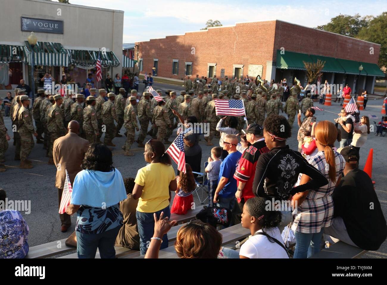 Spectators wave American flags as Soldiers of 3rd Infantry Division