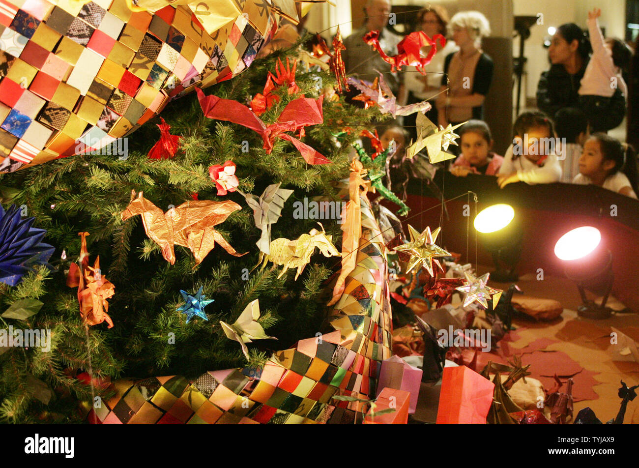 A Holiday Tree Decorated With Origami Ornaments Is On