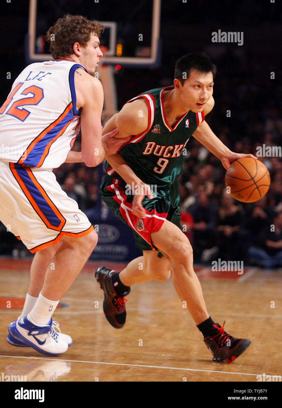 Milwaukee Bucks Yi Jianlian (9) drives past New York Knicks David Lee ...