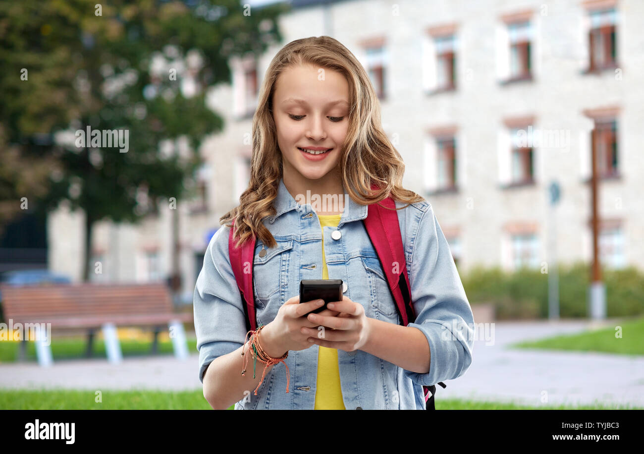 teen student girl with school bag and smartphone Stock Photo