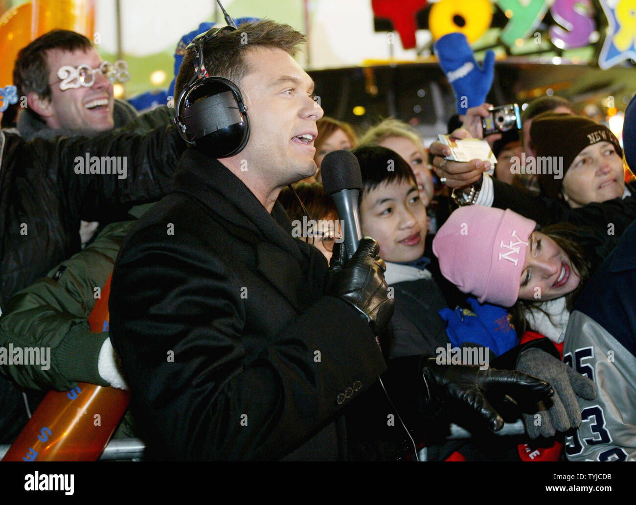 American Idol host Ryan Seacrest does a live broadcast spot before people gathered in Times Square to celebrate New Year's Eve on January 1, 2008 in New York. (UPI Photo/Monika Graff). Stock Photo