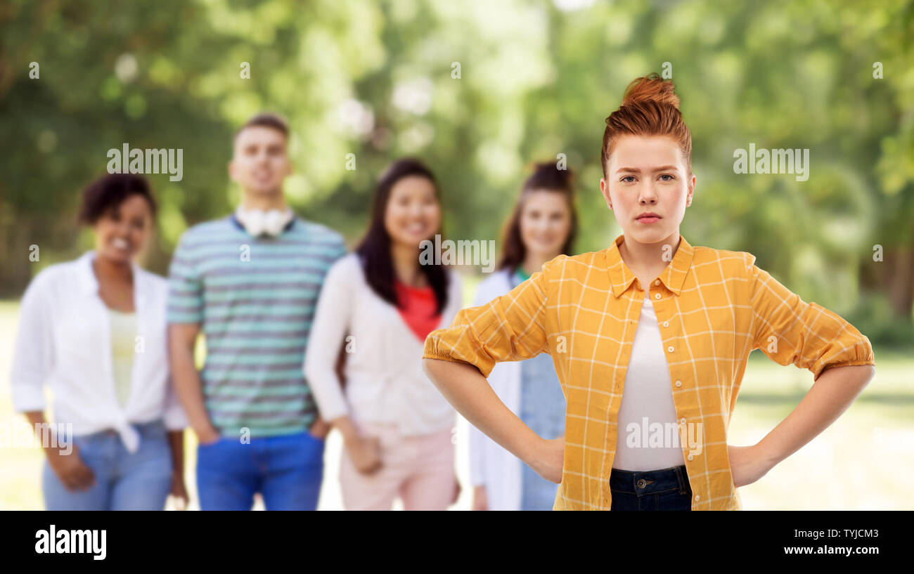 displeased redhead teenage girl with hands on hips Stock Photo