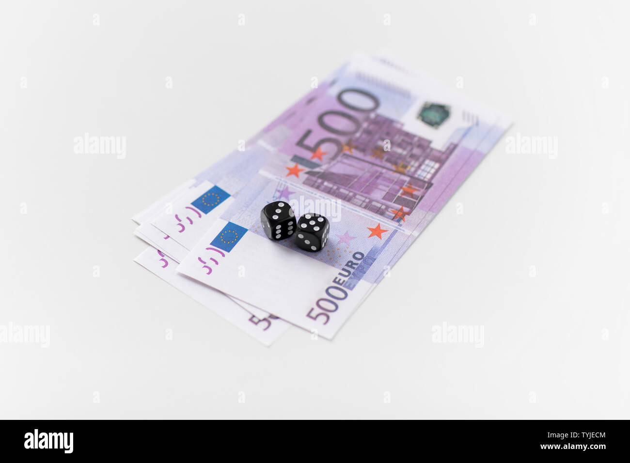 close up of black dice and euro money Stock Photo