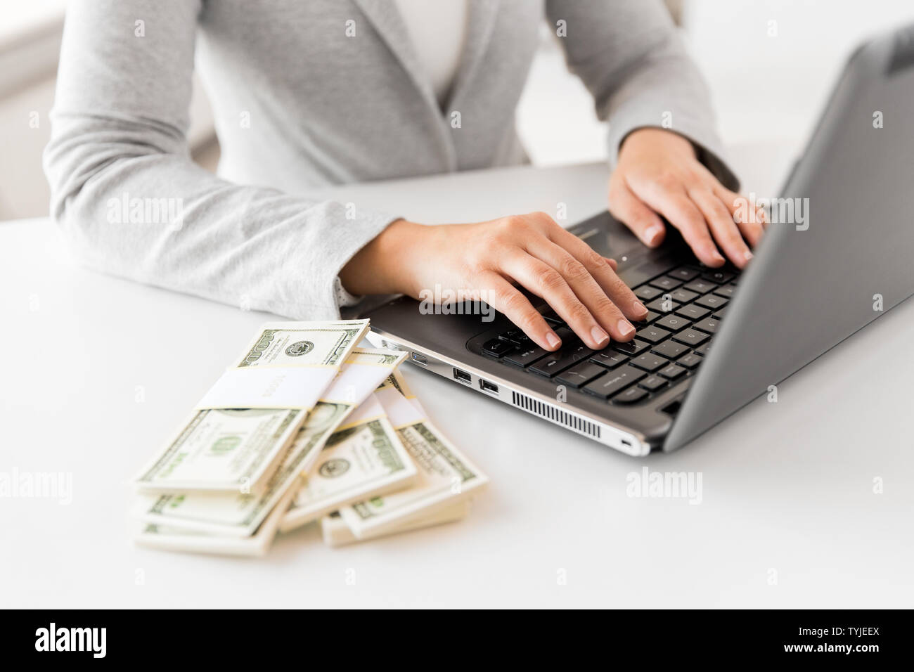 close up of businesswoman with laptop and money Stock Photo