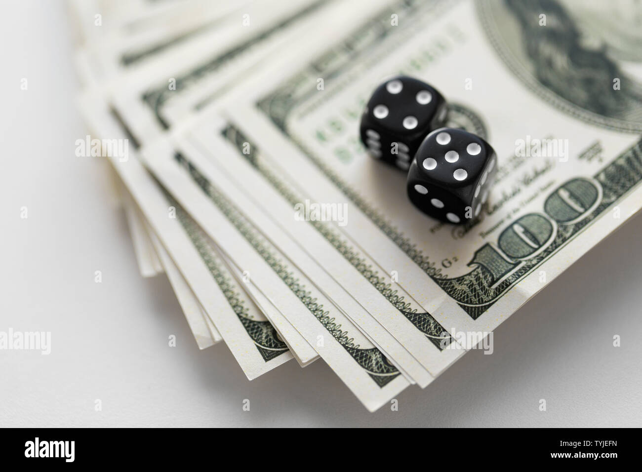 close up of black dice on dollar money Stock Photo