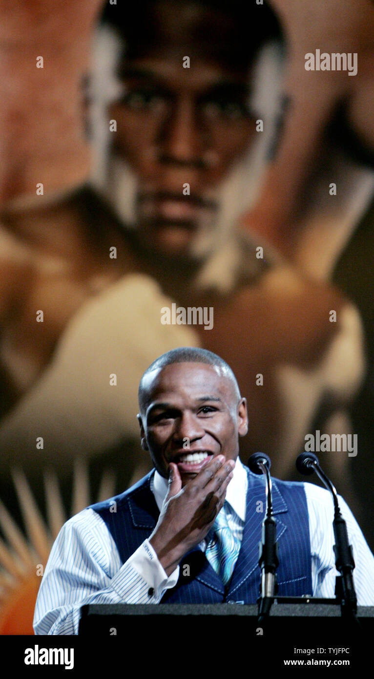 Lightweight boxer Floyd 'Money' Mayweather speaks as a poster of his likeness is seen behind him during the Wrestlemania XXIV press conference held at the Hard Rock Cafe on March 26, 2008 in New York. Mayweather will take on Big Show during the pro wrestling event held in Orlando, Florida on March 30. (UPI Photo/ Monika Graff) Stock Photo