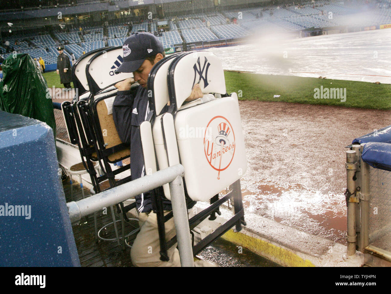 A stadium employees carries away chairs 