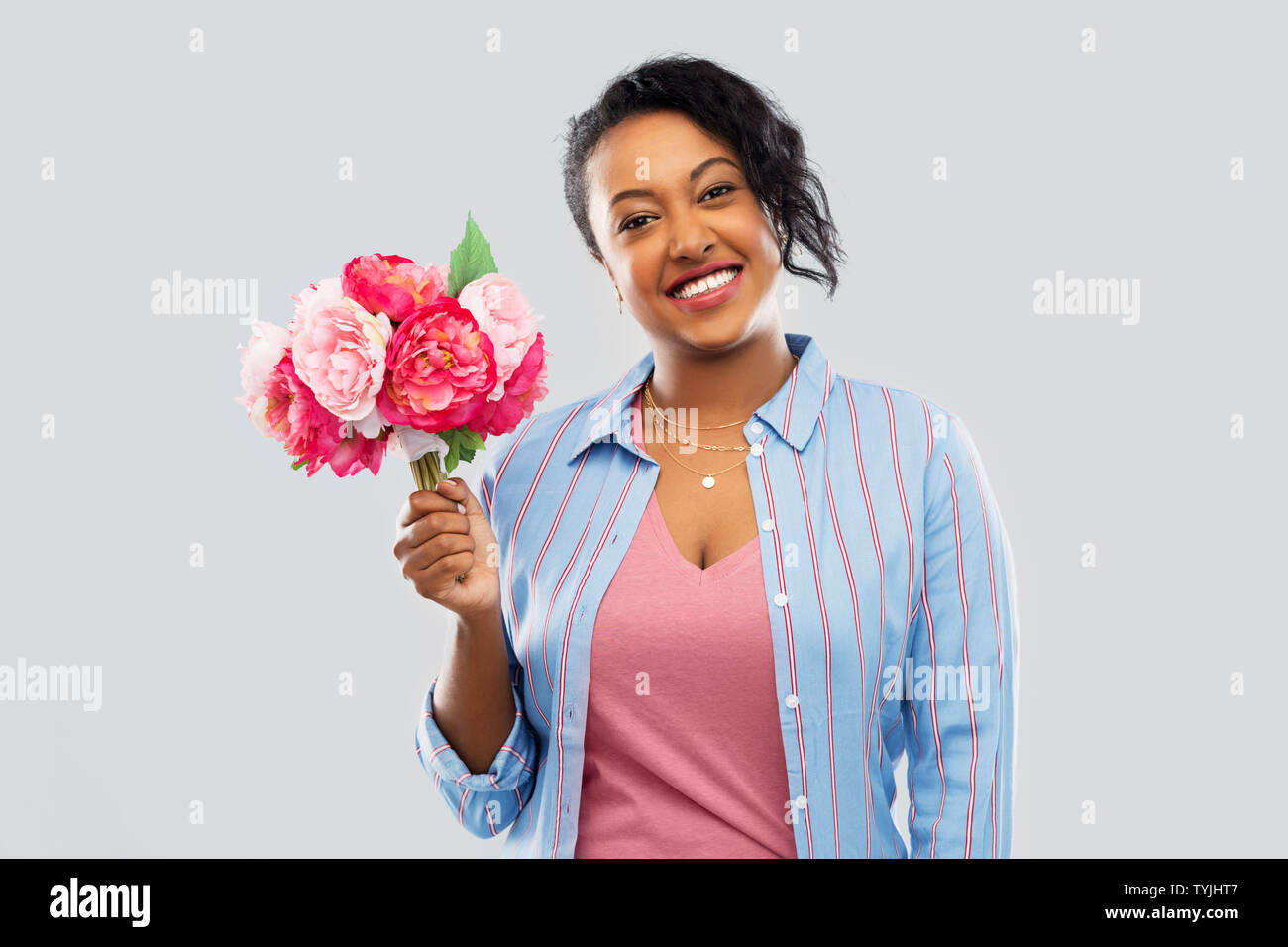 happy african american woman with bunch of flowers Stock Photo - Alamy