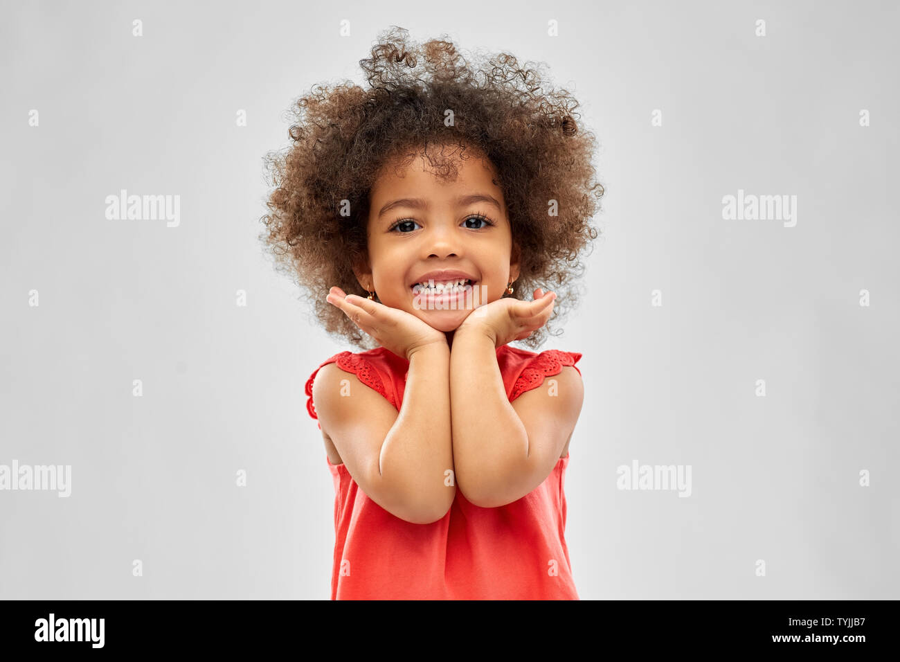 happy little african american girl over grey Stock Photo - Alamy
