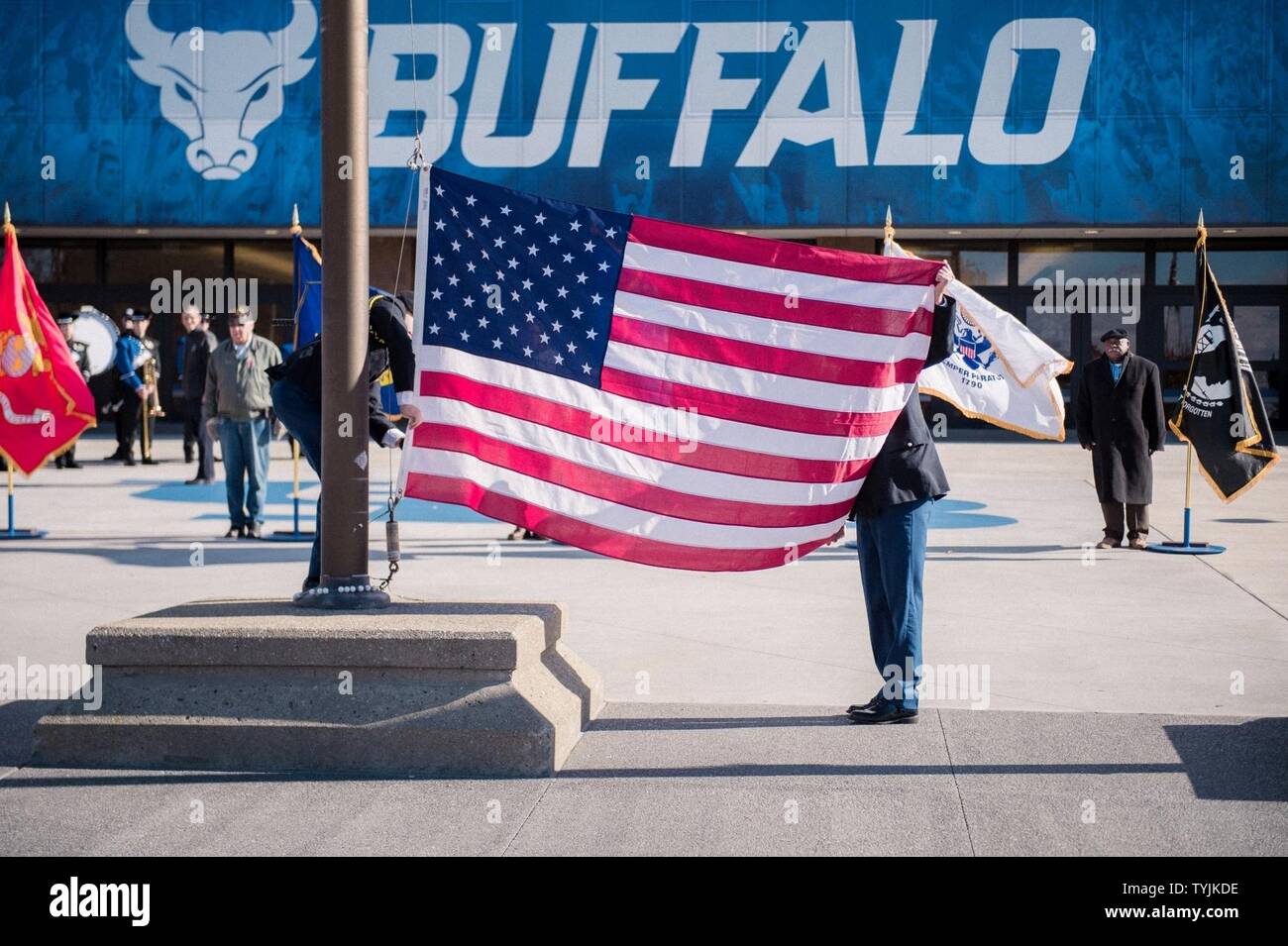 The American Flag Is Prepared To Be Raised And Then Lowered To