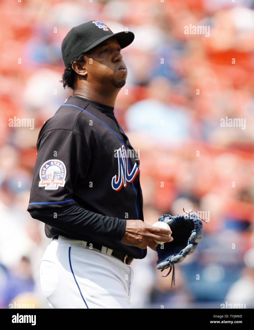 New York Mets starting pitcher Pedro Martinez smiles as he reaches