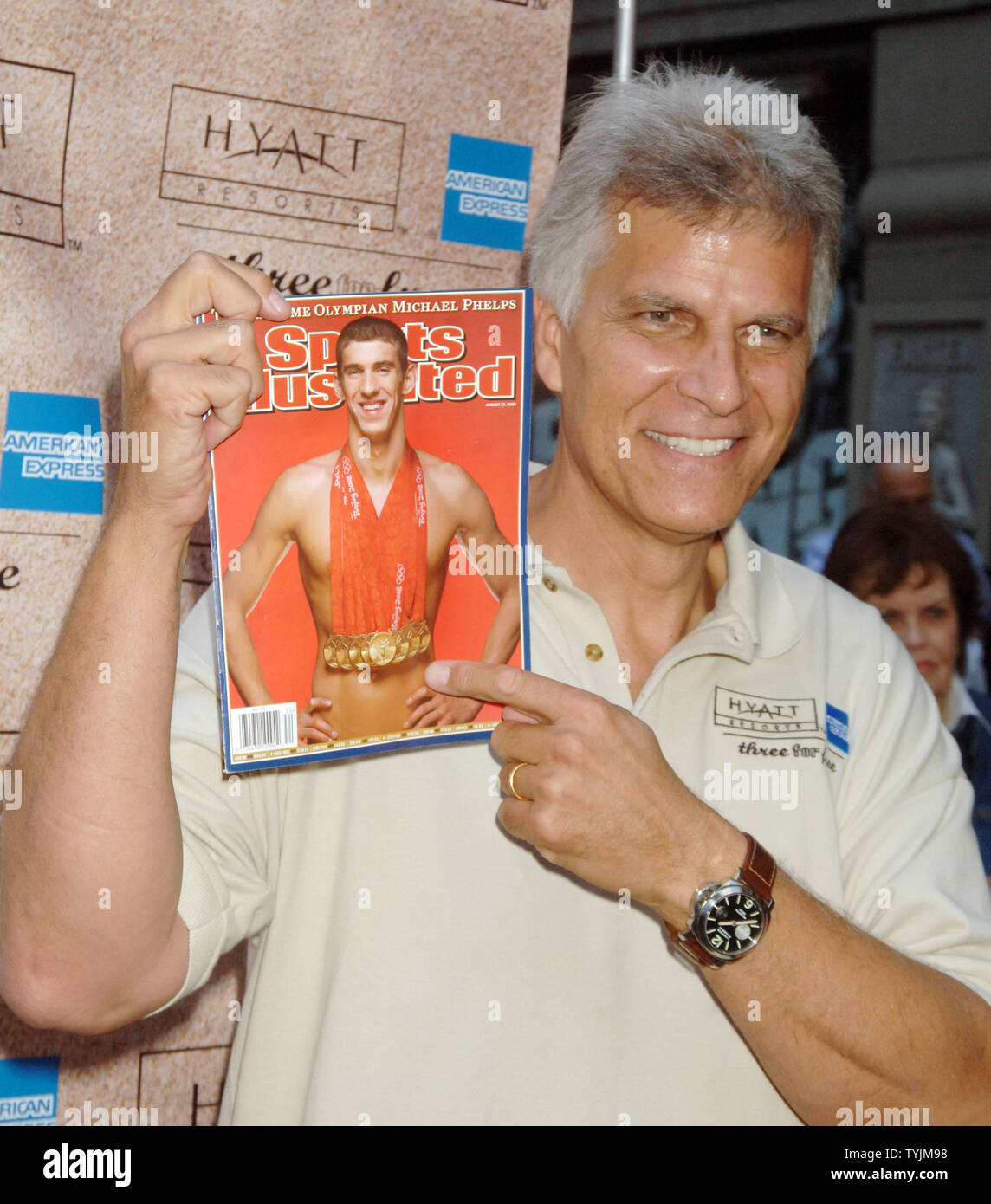 Olympic swimming champion Mark Spitz admires the cover of Sports Illustrated  magazine featuring Michael Phelps whose 8 gold medal wins at the Bejing China 2008 Olympics finally broke Spitz 1972 record of 7 gold. Spitz was at a promotional gig for the Grand Hyatt hotel in New York on August 20, 2008.   (UPI Photo/Ezio Petersen) Stock Photo