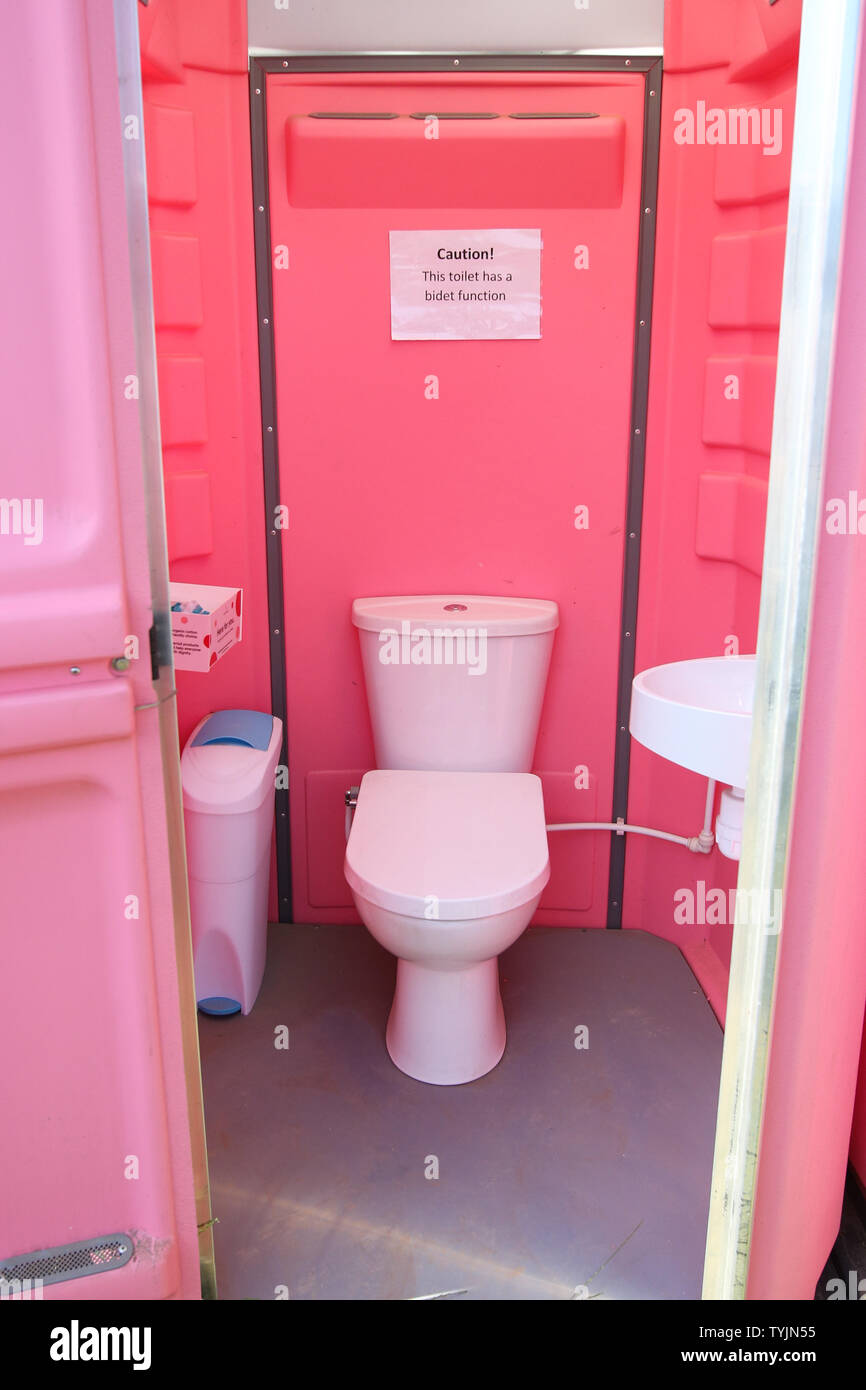 The female only toilets at Glastonbury Festival, at Worthy Farm in Somerset. Water aid has set up specially designed private cubicles to meet womenÕs needs, with sanitary disposal facilities, water for washing, a shelf, hook and extra space. and female urinals where users are given a shepees have the option for biodegradable tampons. Stock Photo
