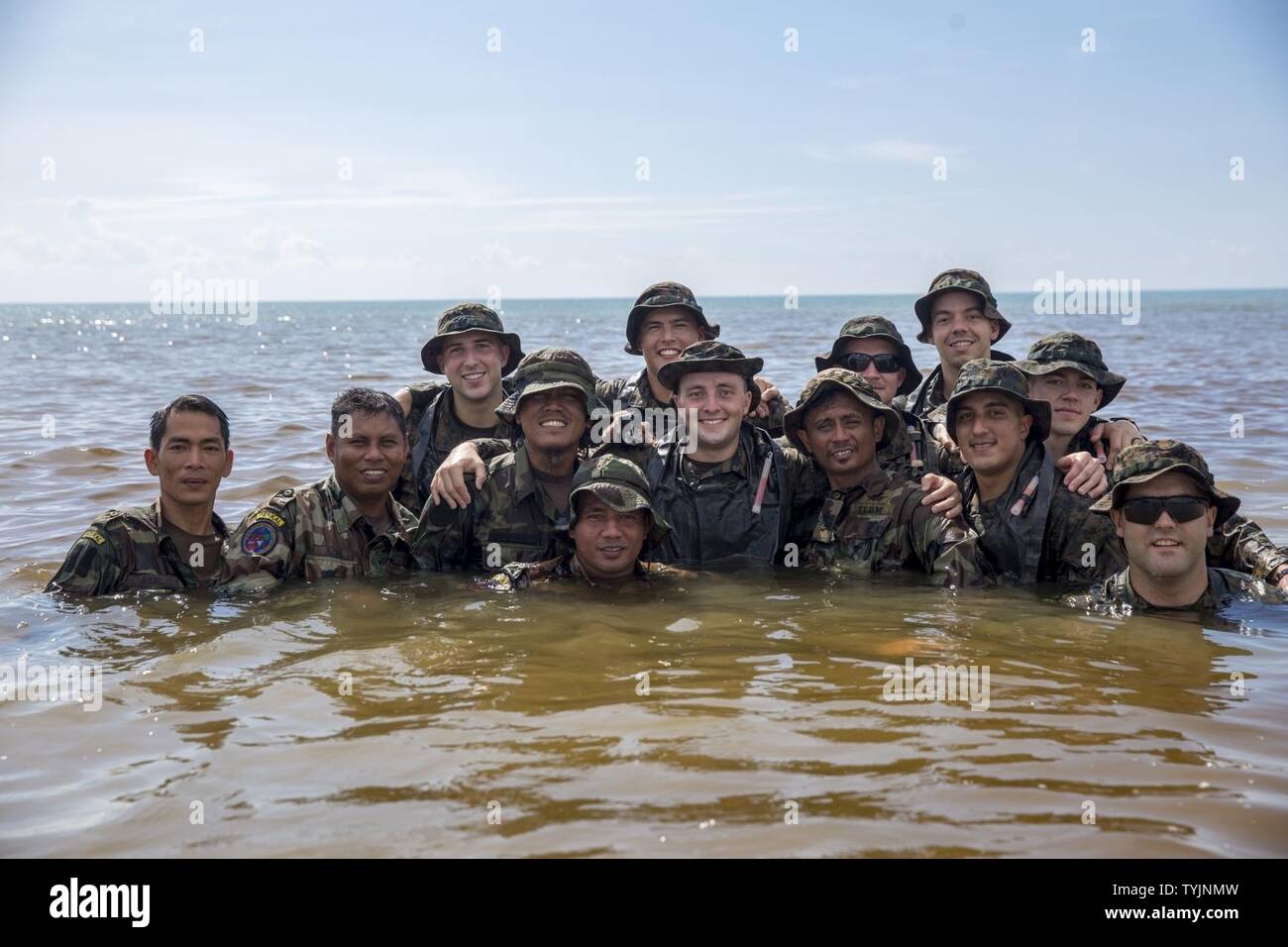 SABAH PROVINCE, Malaysia (Nov. 12, 2016) U.S. Marines and Malaysian Sailors pose for a picture during combat rubber raid craft usage training during Exercise Tiger Strike 16, in the Sabah Province, Malaysia, Nov. 12, 2016. Tiger Strike 16 is an opportunity for Malaysia and the United States armed forces to strengthen military-to-military partnerships, and increases the ability of all participants to plan, communicate and execute amphibious operations. The Marines are with the 11th Marine Expeditionary Unit’s Maritime Raid Force and the Sailors are with Malaysian Naval Special Warfare Forces. Stock Photo