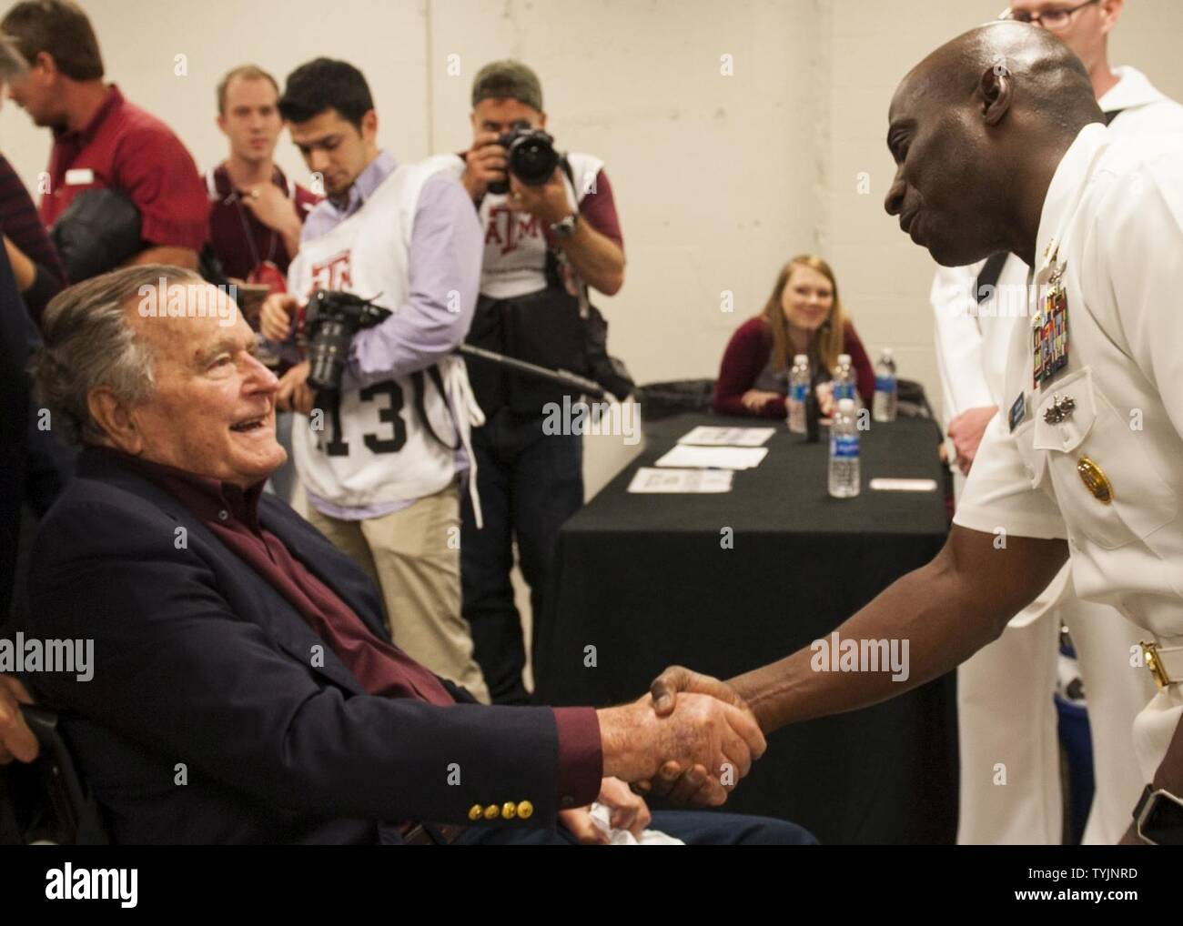 COLLEGE STATION, Texas (Nov. 16, 2016) USS George H.W. Bush (CVN 77) Command Master Chief Huben Phillips meets former president George H.W. Bush during a military appreciation football game at Texas A&M University. The game is part of a two-day namesake trip to Texas where Sailors engaged with the local community about the importance of the Navy in defense and prosperity. Stock Photo